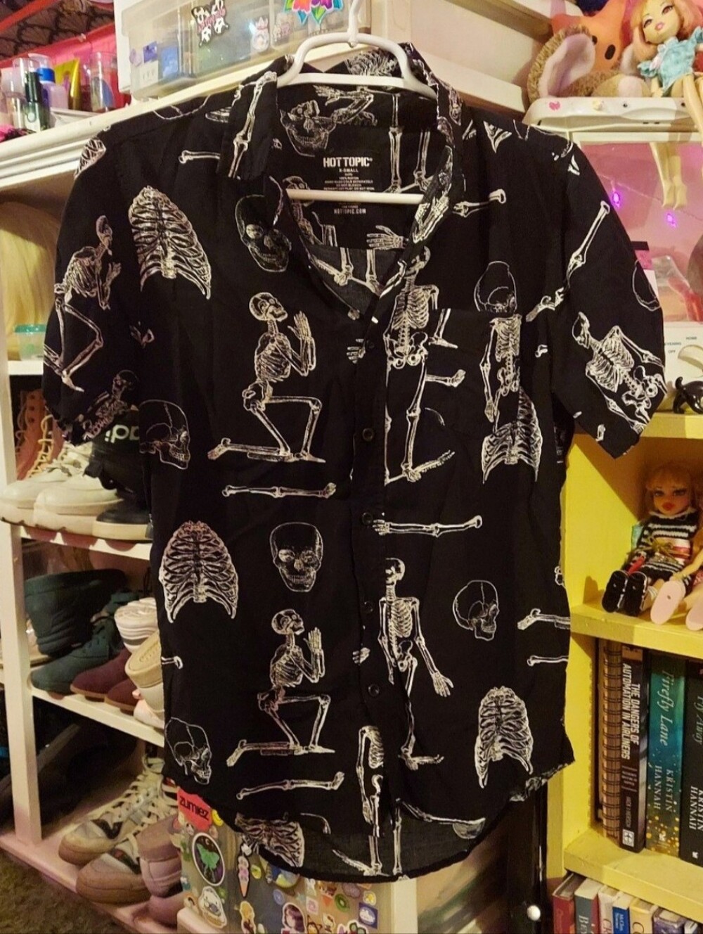 White skeletons on black short sleeve button up collared top